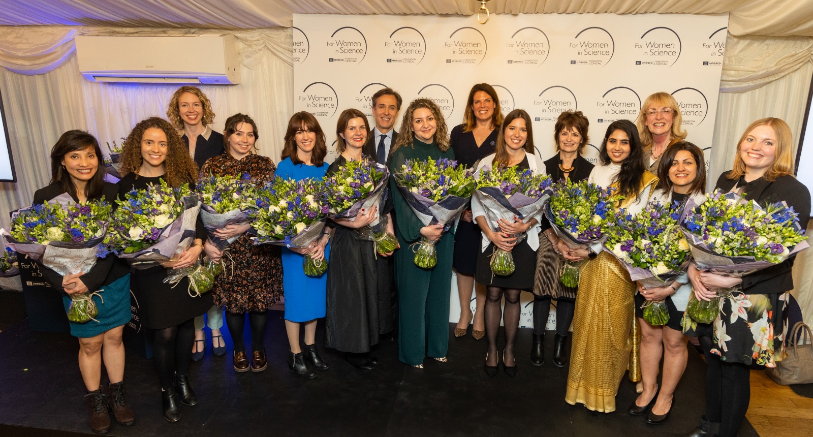 Jessica Cross and other shortlisted candidates posing with flowers
